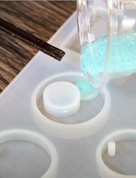 pouring resin into the jewelry molds